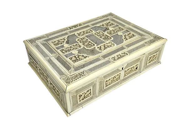 A 19th century Indian carved and reticulated ivory and bone box, with rectangular segmented top opening to reveal a plain interior with silk lining an