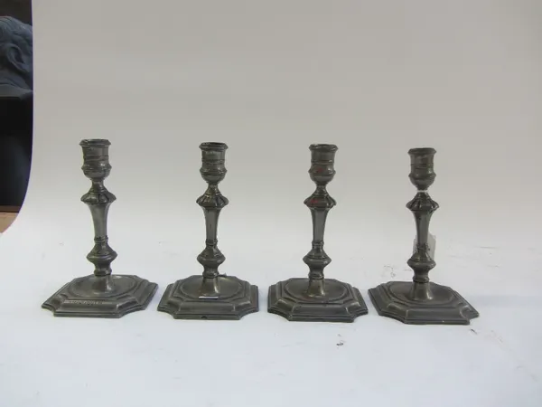 A set of four 18th century pewter candlesticks, each stamped 'MONMOUTH' to the canted square foot, 16cm high. (4).Provenance; The Estate of Fleur Cowl
