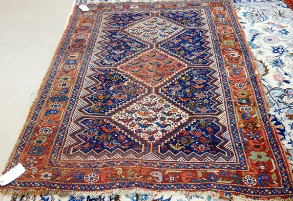 An Afshar Khamseh rug, Persian, the indigo field with a madder and two ivory diamonds, all with chickens, a serrated surround, a madder rosette and br
