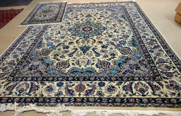 A modern Turkish Duruder carpet, the ivory field with an indigo rosette medallion, matching spandrels, floral sprays, a complementary ivory border, 35