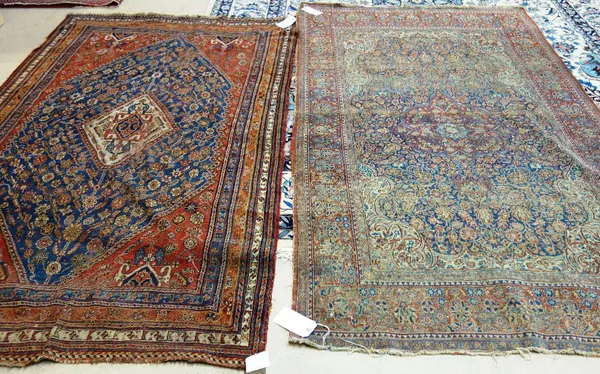 A Ghasghai rug, Persian, the indigo flower-filled field with an ivory diamond, madder spandrels, three borders, 220cm x 140cm, and an Esfahan rug, Per