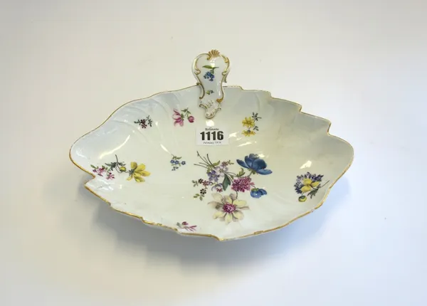 A Meissen leaf shaped dish, circa 1745-55, set with a scroll moulded handle and painted with scattered flowers beneath an ozier moulded border, (a.f),