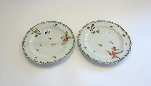 A pair of Chelsea plates, circa 1760, each painted with scattered flower sprays and sprigs inside a turquoise and brown feather-edged rim, brown ancho
