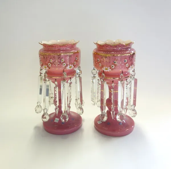 A pair of Victorian pink glass lustres, gilt foliate decorated and hung with two tiers of graduated glass drops (a.f), 36cm high (2).