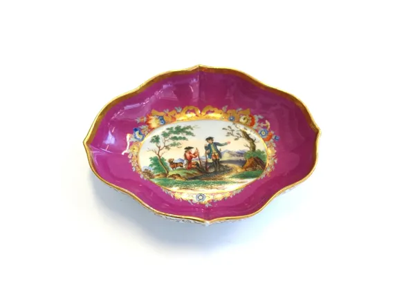 A Meissen porcelain dish, 19th century, decorated with a gentleman and dog on a hunt within a wide pink and gilt foliate border, blue crossed swords m