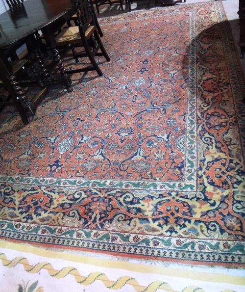 An Oriental carpet of Mahal stye with a terracotta field and allover design, 291cm x 402cm.
