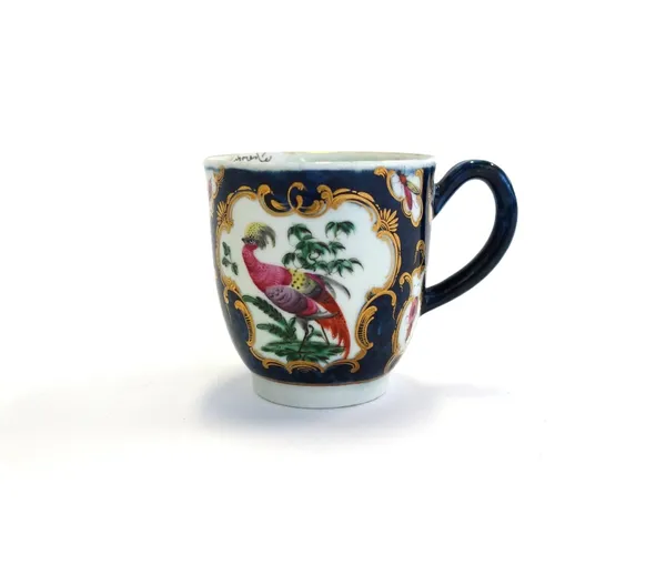A Worcester coffee cup, circa 1770, painted with exotic birds and insects within gilt-edged mirror and vase shaped panels against a blue scale ground,