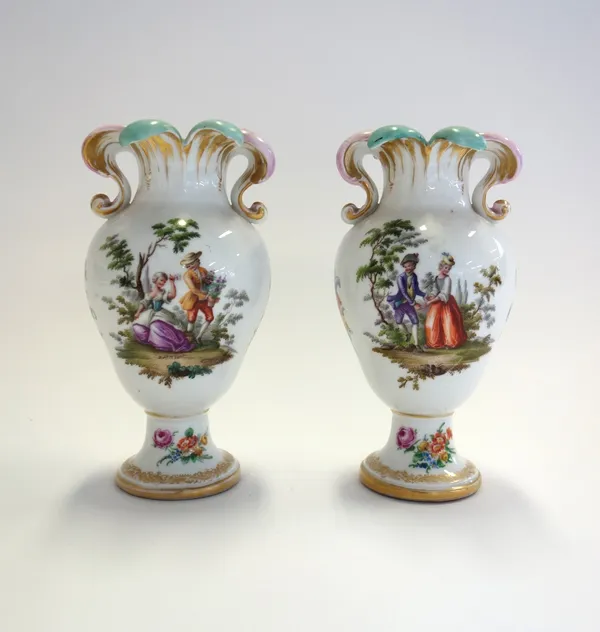 A pair of K.P.M Berlin porcelain vases, circa 1900, each shaped rim over a footed body, decorated with gallant and companion at leisure, blue printed