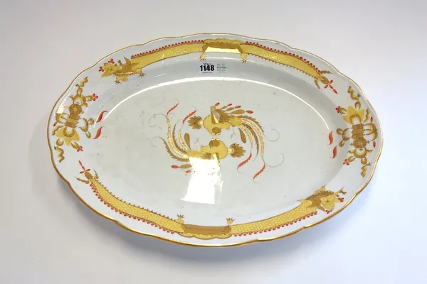 A Meissen porcelain oval charger, circa 1900, centrally decorated with stylized exotic birds within a shaped border decorated with gilt yellow dragons