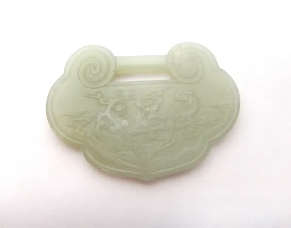 A Chinese pale celadon jade buckle, 19th/20th century, of ruyi form, carved in low relief on one side with a bird perched in flowering branches, the r