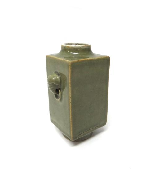 A Chinese celadon glazed cong vase, probably 19th century, of typical square section set with elephant mask and ring handles, 18.5cm. high.