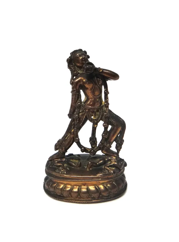 A Tibetan copper alloy figure of Sarvabuddha Dakini, probably 19th century, standing in alidhasana with both feet resting on a prostrate dwarf, wearin