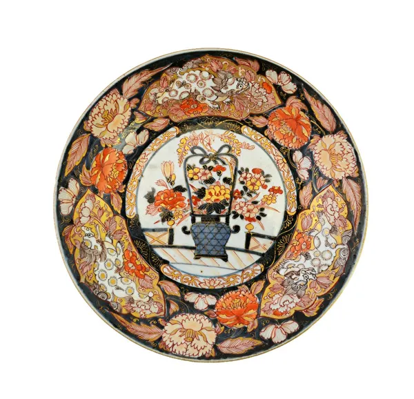 A Japanese Imari plate, Edo period, late 17th/early 18th century, painted in the centre with a basket of flowers, the border painted with flowers and