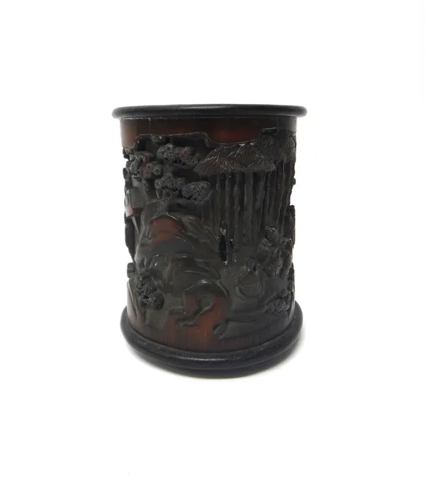 A Chinese bamboo brush pot, 20th century, carved and pierced with figures beside bamboo and pine trees, incorporating a six character mark, 17cm. high
