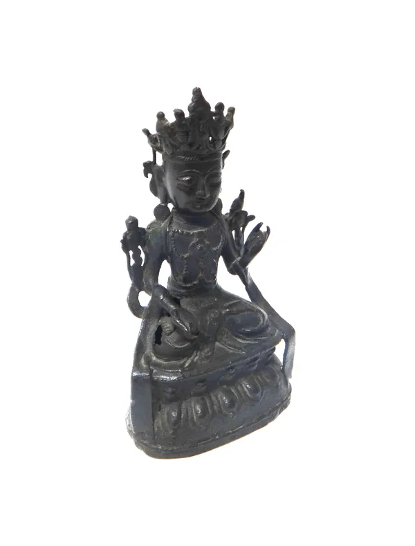 A Chinese bronze figure of a bodhisattva, Ming dynasty, 17th century, seated on a double lotus base, wearing a tiara, celestial scarf and jewellery, 1