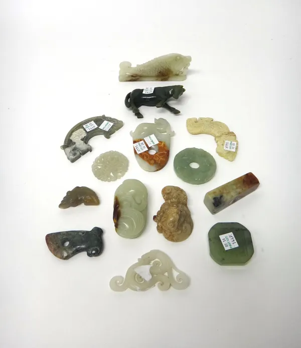 A group of fourteen Chinese jade and hardstone carvings, some in archaic style, including; a celadon jade bi disc carved with chilong; a carving of a