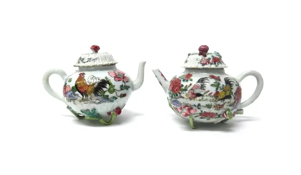 A pair of Chinese famille-rose globular teapots and covers, Yongzheng, each moulded with chrysanthemum petals and painted with cockerels, applied in h