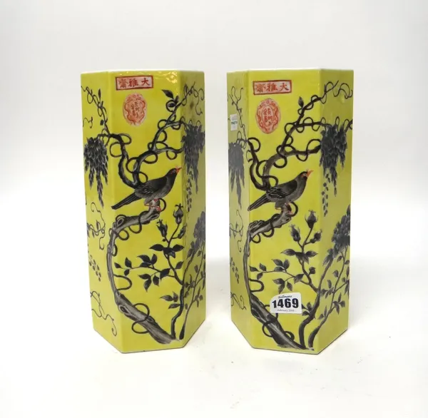 A pair of Chinese `Dayazhai' style yellow ground hexagonal vases, 20th century, each painted in grisaille with a bird perched in branches of wisteria,