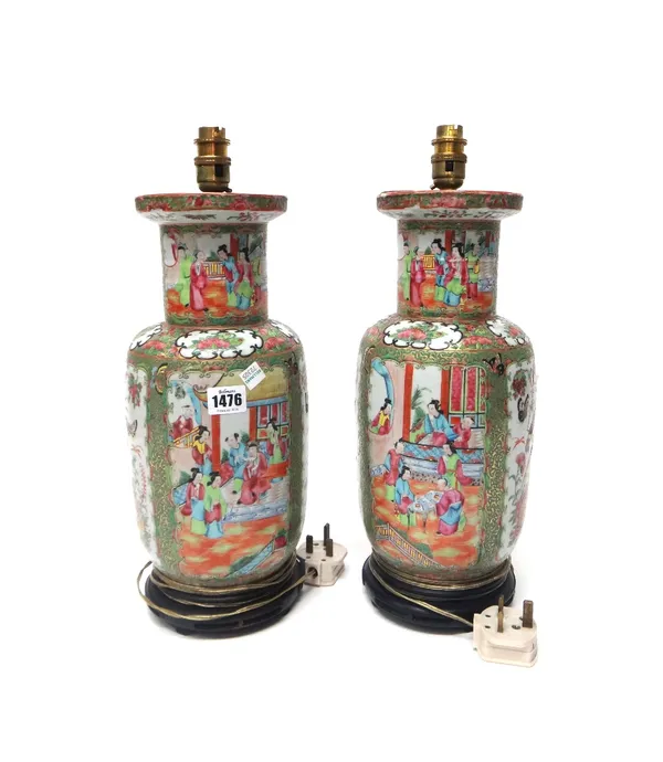 A pair of Canton famille-rose baluster vases, 19th century, painted with panels of figures at leisure and panels of birds and insects amongst flowers,