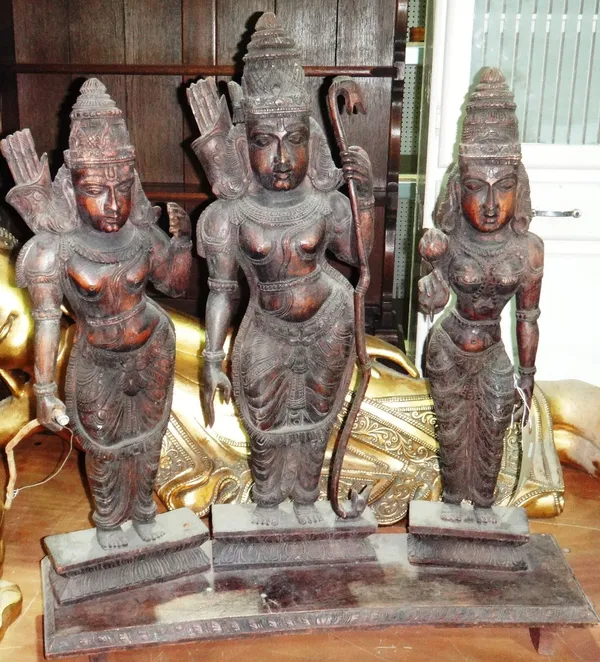 A 20th century carved hardwood sculpture depicting three Indian women.