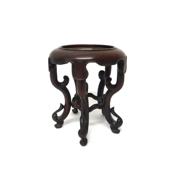 A Chinese hardwood vase stand, with circular dished top, shaped apron and four scroll supports, 20.5cm.high.