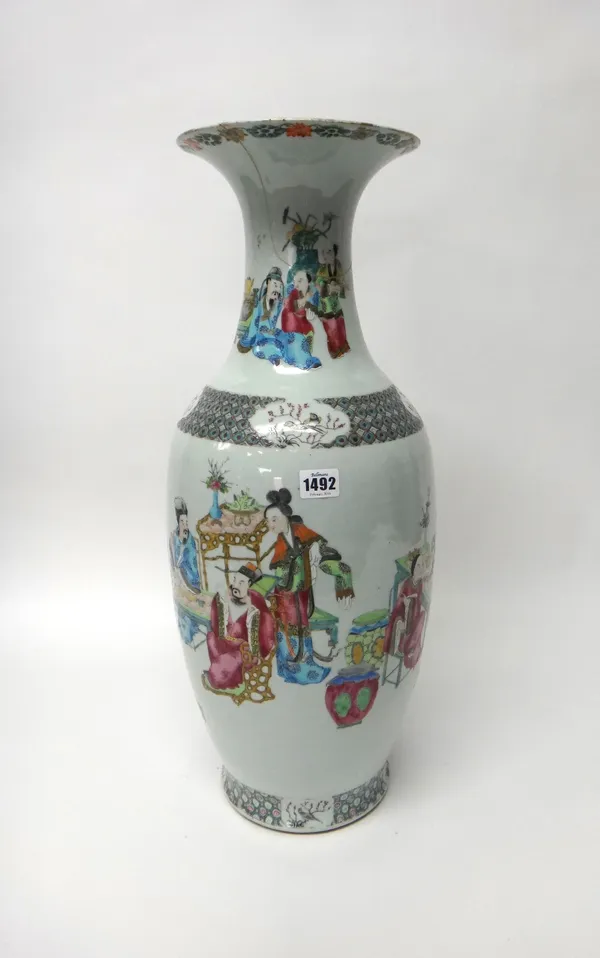 A large Chinese famille-rose baluster vase, 19th century, well painted with figures seated at tables and standing inside cell pattern borders reserved