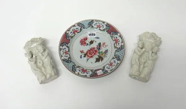 A Chinese famille-rose plate, Qianlong, painted with peony, chrysanthemum an scrolls inside a diaper panelled border reserved with flower panels, (a.f