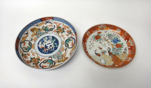 A Japanese Imari shallow bowl, Meiji period, painted in the centre with pine, prunus and bamboo, inside a wide border filled with mythical creatures a