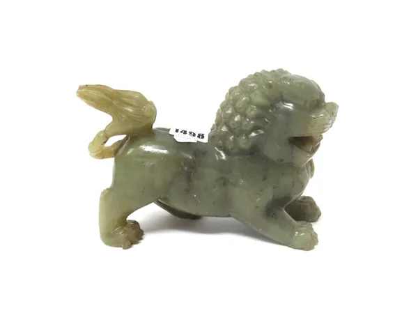 A Chinese soapstone figure of a buddhist lion, 20th century, carved crouching with teeth bared, 18cm.length.