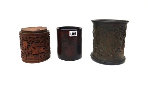 A Chinese bamboo brush pot, incised with a figure on a buffalo, the reverse with calligraphy, 13.5cm.high; another brush pot decorated in relief with