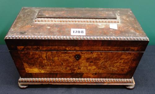 A William IV pollard oak and mahogany sarcophagus shaped tea caddy on bun feet, 31cm wide.