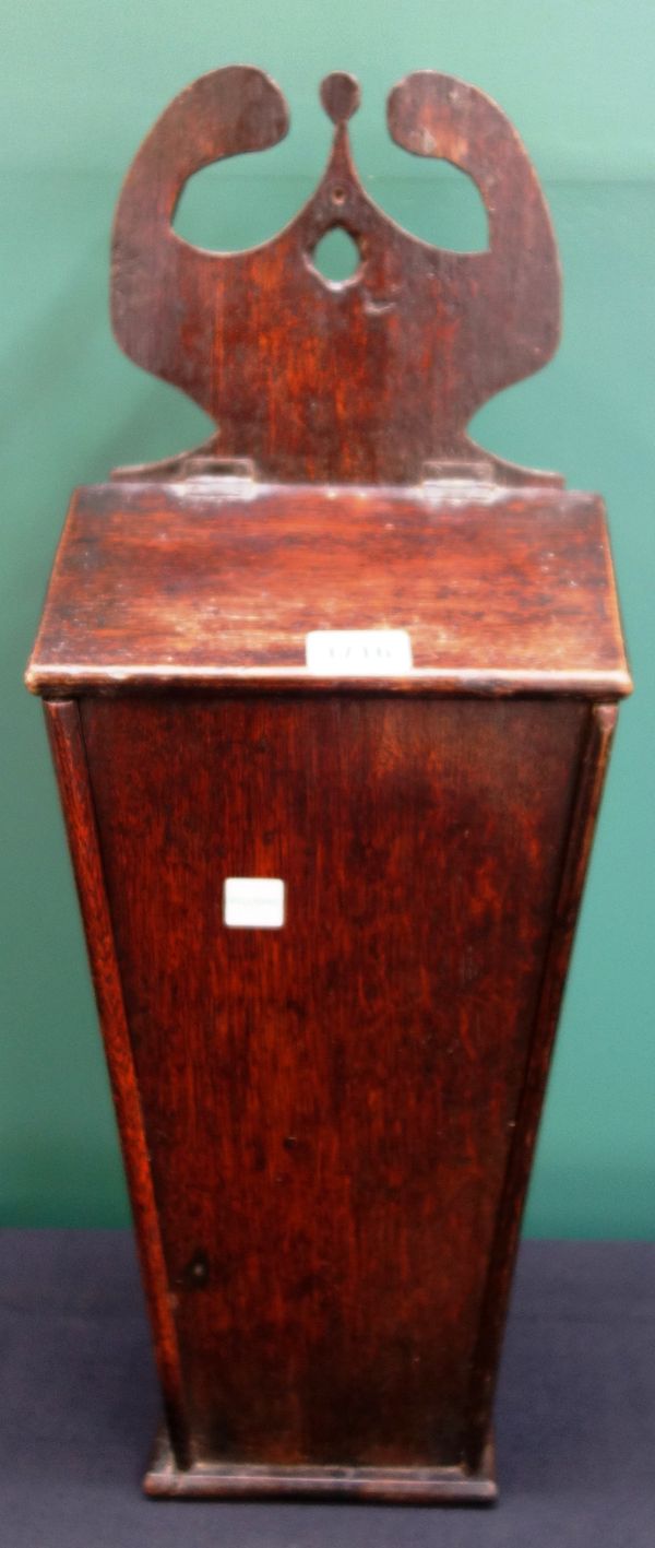 A George III oak hanging candle box, with fret carved hanging bracket over tapering body, 52cm high.