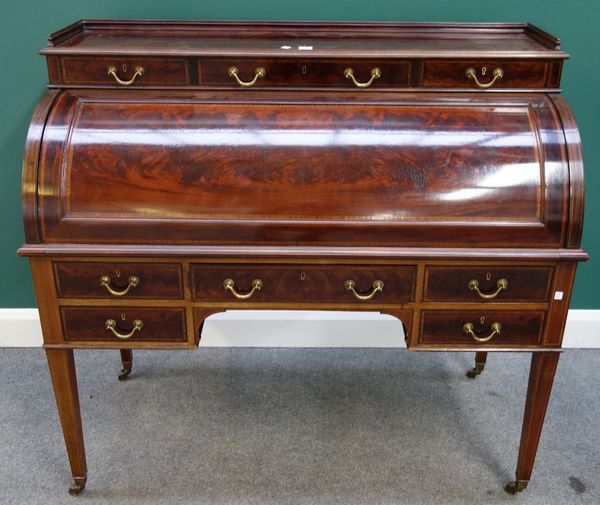 A late 19th century satinwood banded mahogany cylinder bureau, with three upper frieze drawers over fitted slide-out interior and three further frieze