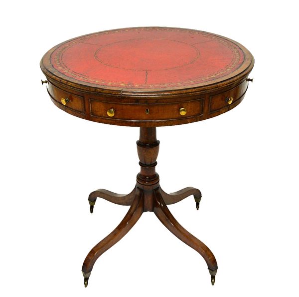 A George III mahogany drum table, with gilt tooled rouge leather top over three true and three dummy frieze drawers, on turned column and four downswe