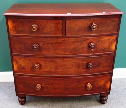 An early 19th century mahogany bowfront chest of two short and three long graduated drawers on  turned feet, 106cm wide.