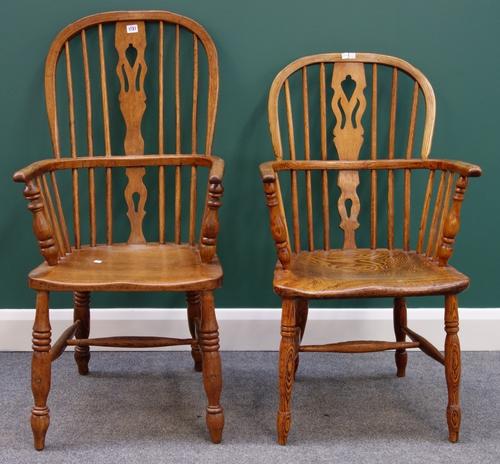 An early 19th century ash and elm Windsor chair with pierced splat and turned supports, together with another simillar. (2)