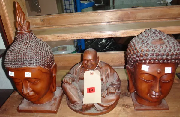 A hardwood carved model of Buddha, together with two hardwood Buddhistic heads.