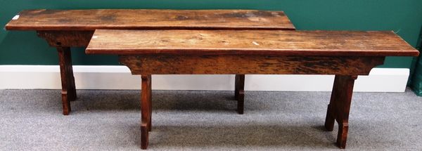 A pair of elm benches, each on shaped slab end supports, 137cm wide.