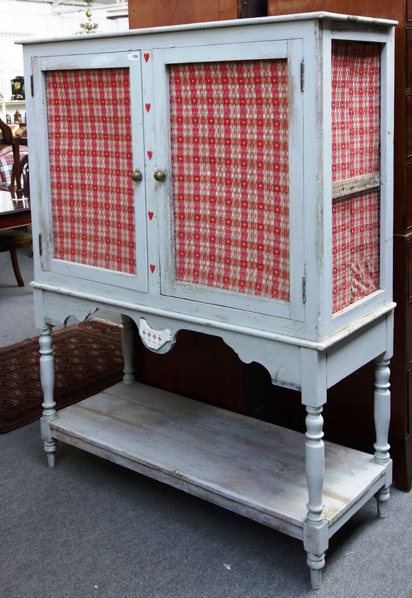 A grey painted two door meat safe, on turned supports united by platform undertier, 129cm wide.