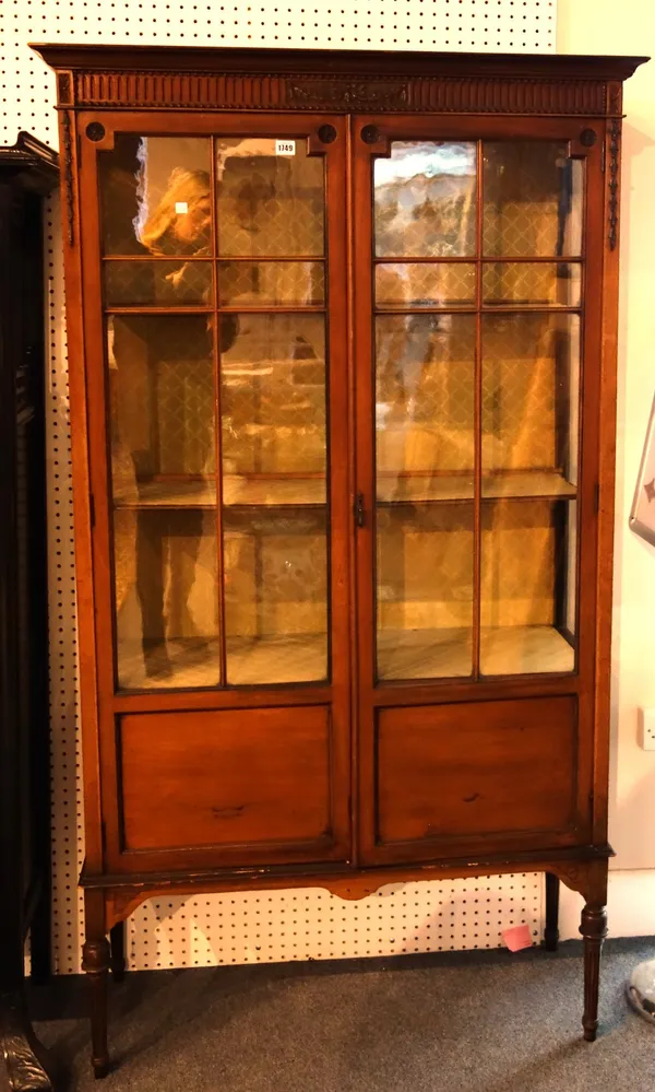 A late 19th century mahogany glazed two door display cabinet on tapering fluted supports, 100cm wide.