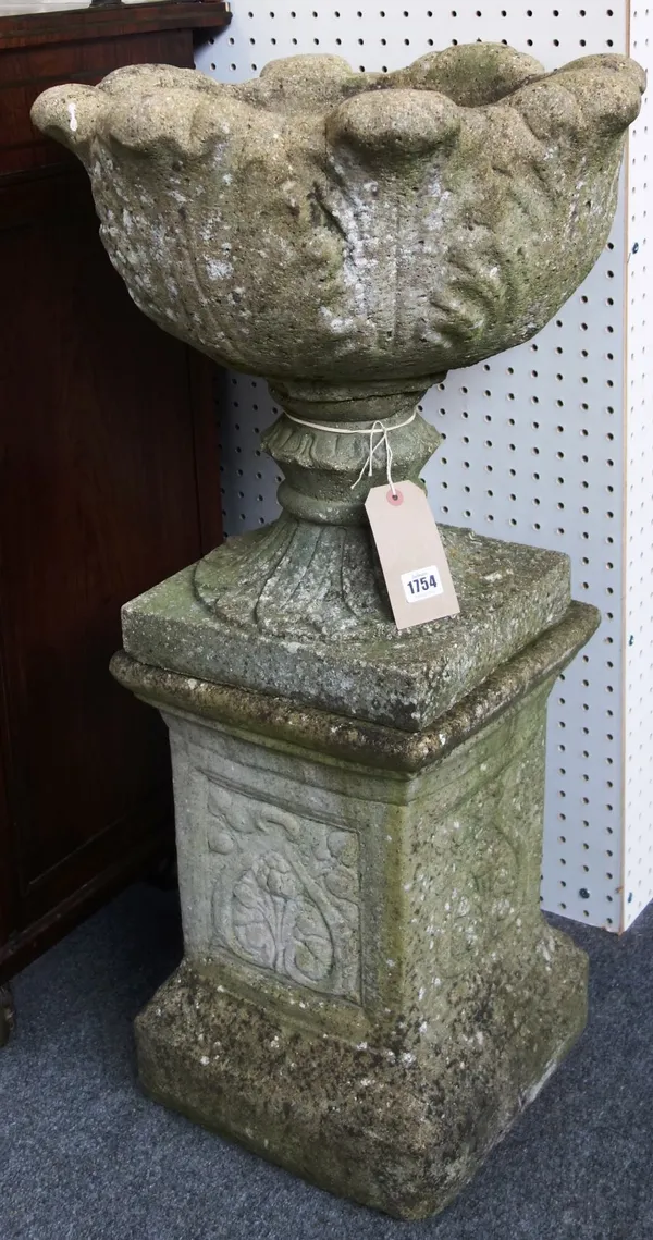 A pair of reconstituted stone jardinieres, with leaf moulded bodies on turned socles and square bases, 90cm high.