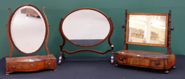 A George III mahogany toilet mirror with serpentine three drawer base, 42cm wide, together with a similar William IV toilet mirror, 48cm wide, and a s