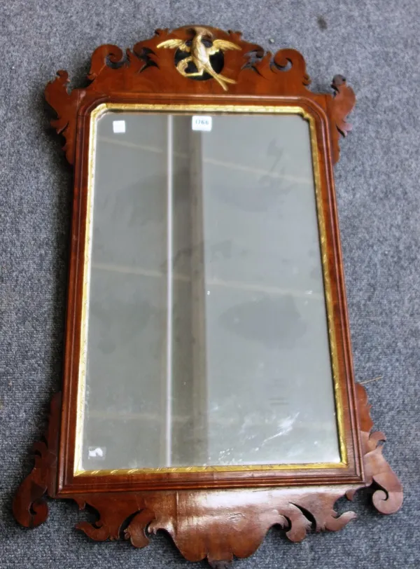 A George III parcel gilt fret cut wall mirror with ho ho bird surmount, 55cm wide x 92cm high.