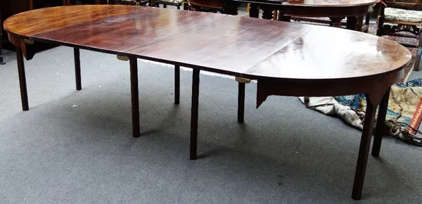 A George III mahogany 'D' end dining table on eight canted square supports, to include two extra leaves, 135cm wide, each console 65cm deep, each leaf