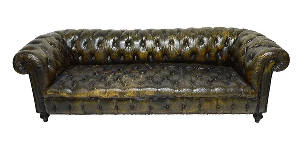 A green leather button upholstered Chesterfield sofa, with studded decoration, on turned ebonised supports, 227cm wide.  Illustrated