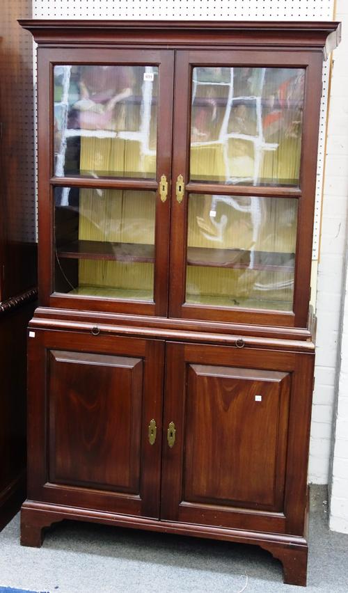 A George III mahogany bookcase cupboard, the pair of glazed doors over brushing slide and pair of panelled cupboards, on bracket feet, 101cm wide x 18