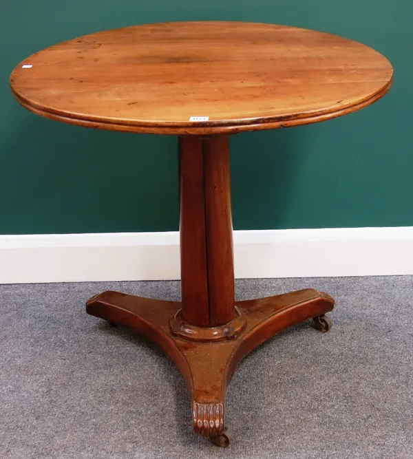 An early 19th century French fruitwood occasional table, the circular top on a turned column and triform platform, 80cm wide.
