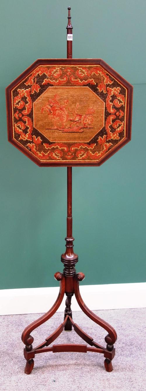 A Regency mahogany pole screen on three downswept supports united by concave stretchers.