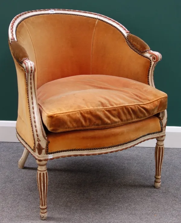 A Louis XV style cream painted parcel gilt tub back fauteuil, with serpentine seat on fluted baluster supports.