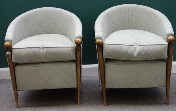 A pair of 20th century copper and bronze framed tub back armchairs with studded ball finials and decorated backs on tapering turned splayed supports.